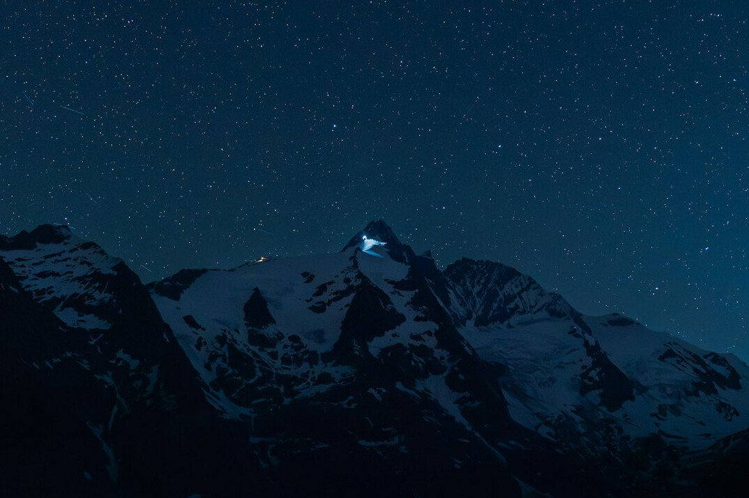 Snowy mountain landscape under a starry sky