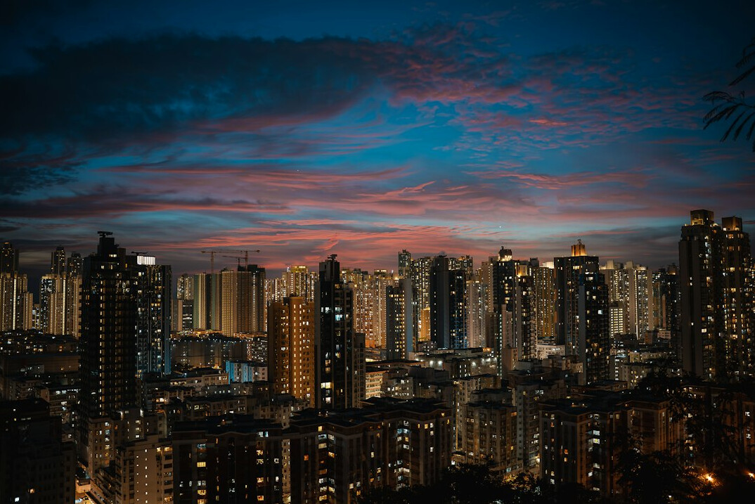 City skyline at dusk with lit buildings