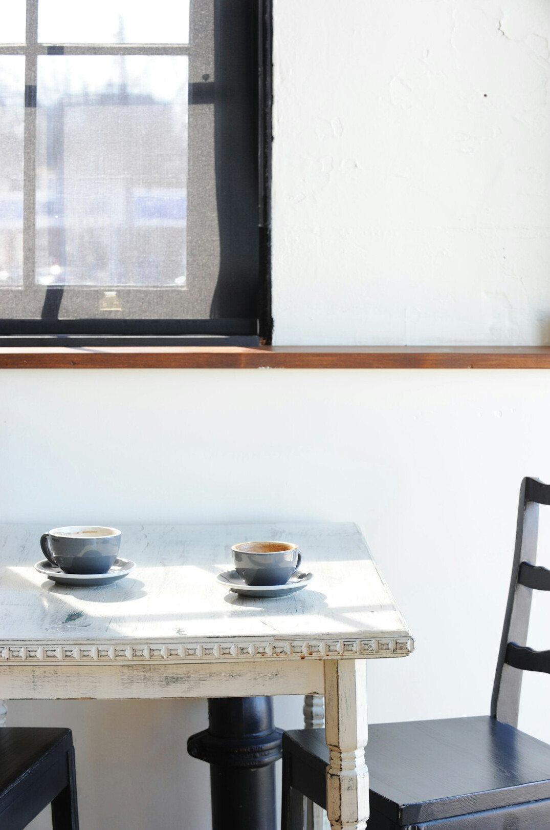 Cup of coffee on a cafe table by the window